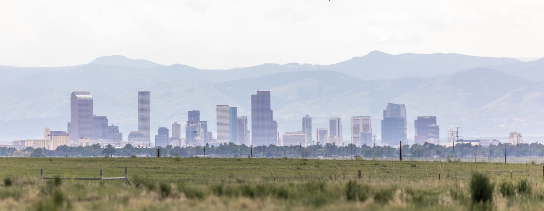 a city skyline with a mountain in the background