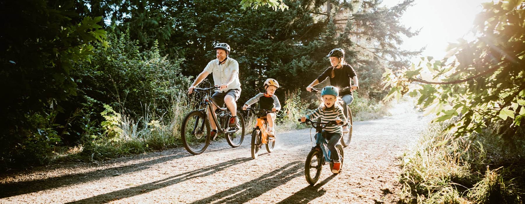 family riding bicycles in a park